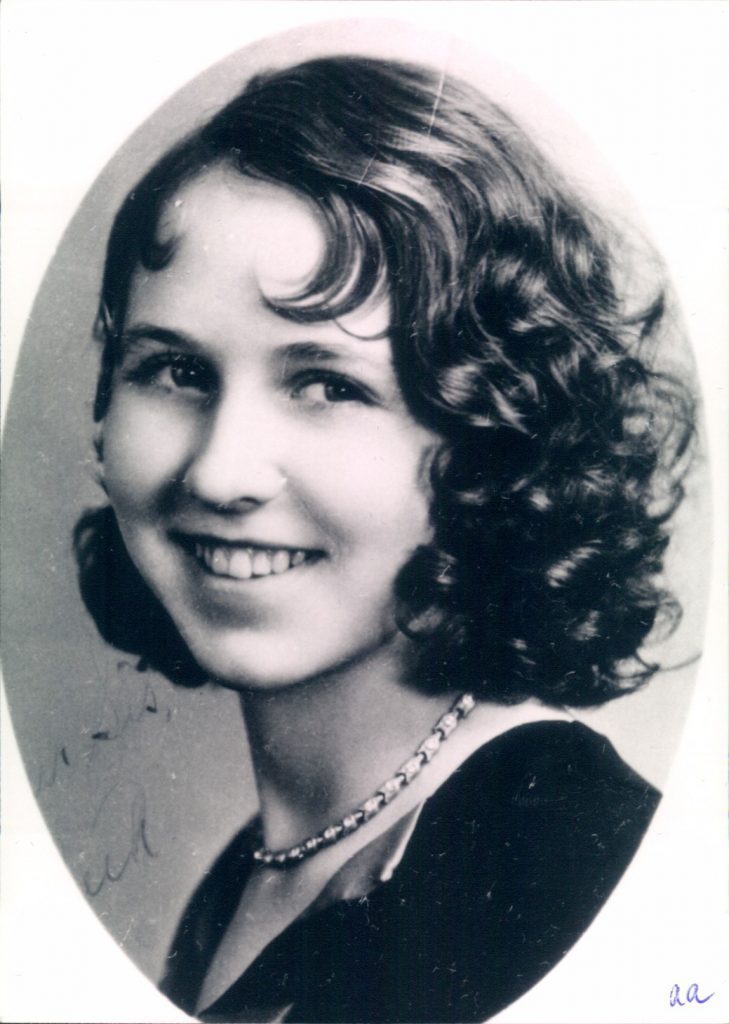 A black and white photo of a woman with curly hair.